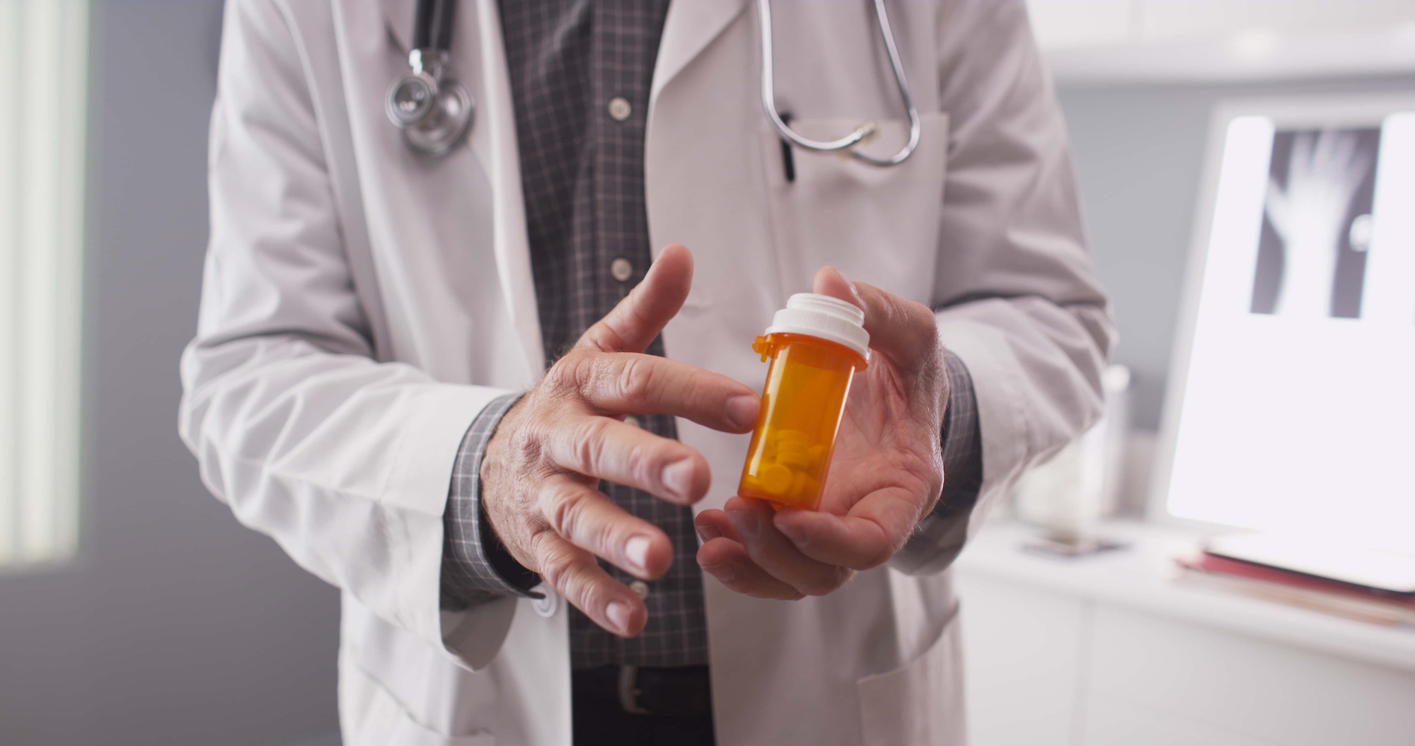 doctor holding prescrption meds
