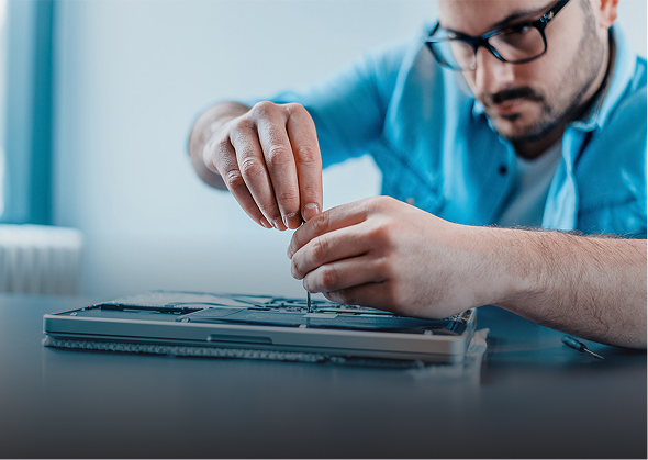Close-up of computer technician fixing laptop hardware