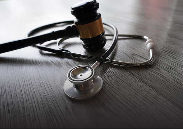 gavel and stethoscope on a desk