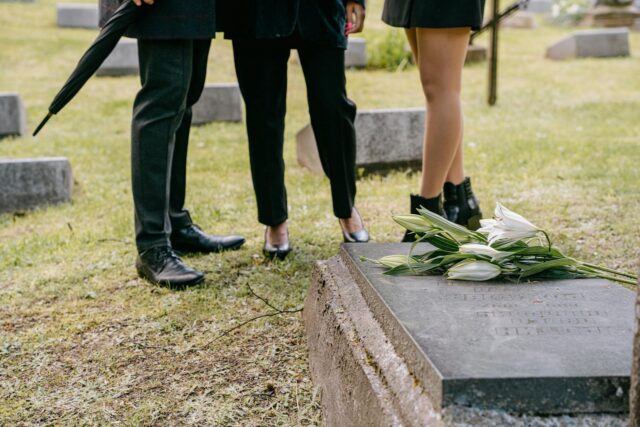 people standing at burial site wrongful death
